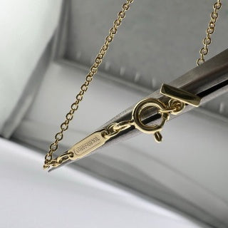 Tiffany necklace with side-set diamonds and a "Smile" pendant.