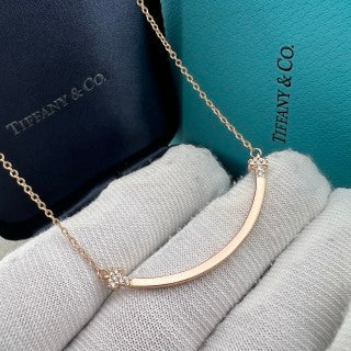 Tiffany necklace with side-set diamonds and a "Smile" pendant.