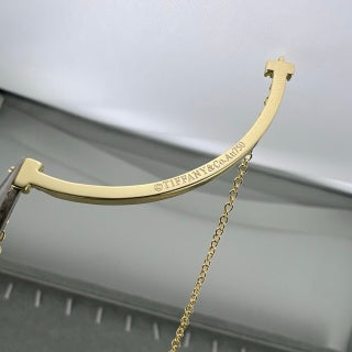 Tiffany necklace with side-set diamonds and a "Smile" pendant.