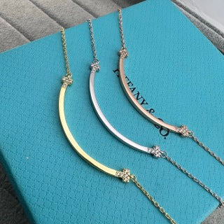 Tiffany necklace with side-set diamonds and a "Smile" pendant.