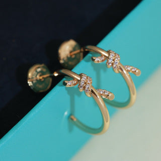 Tiffany Knot Stud Earrings – Polished Finish with Half-Pavé Diamonds