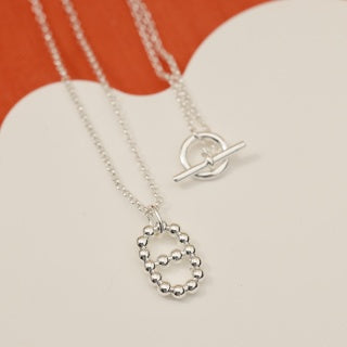 Hermès Beaded Oval Loop Pendant Necklace