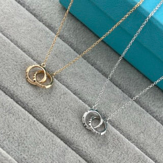 Tiffany & Co. Double-Clasp High-Polish Gold Circle Pendant Necklace with Knife-Edge Detail